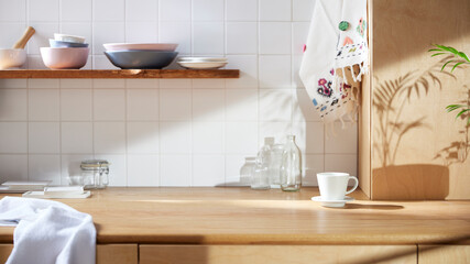 A sunny kitchen with white tile walls, a wooden table and sink.