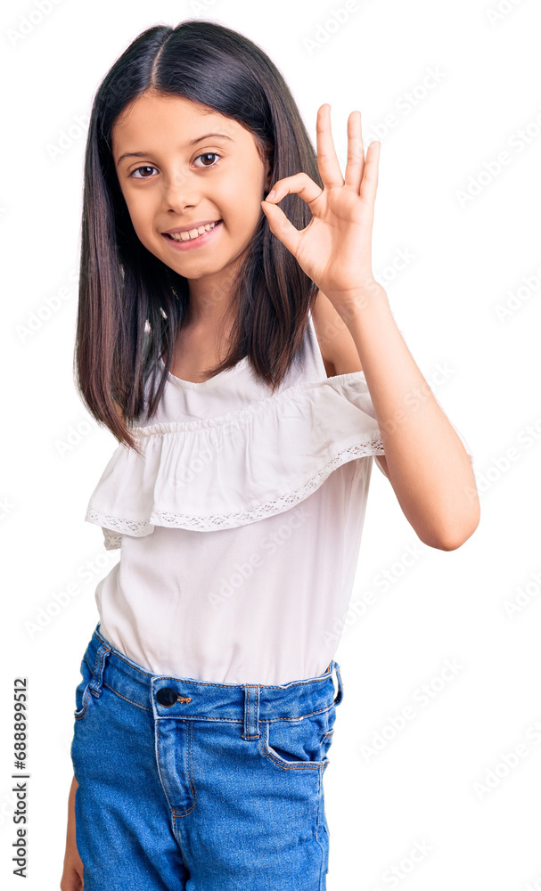 Wall mural beautiful child girl wearing casual clothes smiling positive doing ok sign with hand and fingers. su