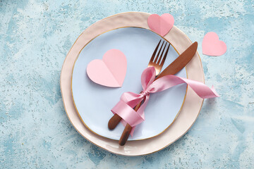 Beautiful table setting for Valentine's Day on blue grunge background