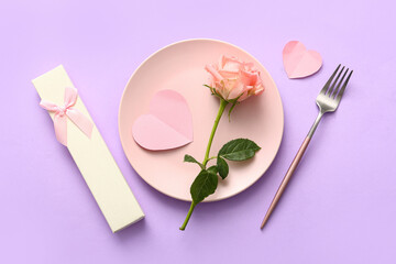 Fototapeta na wymiar Beautiful table setting with rose and gift for Valentine's Day on lilac background