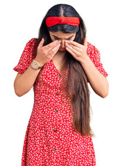 Brunette teenager girl wearing summer dress rubbing eyes for fatigue and headache, sleepy and tired...