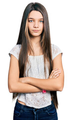 Fototapeta premium Young brunette girl with long hair wearing white shirt skeptic and nervous, disapproving expression on face with crossed arms. negative person.