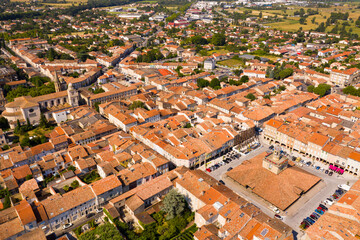 View from drone of houses of Revel town and historic covered market hall at sunny summer day, France