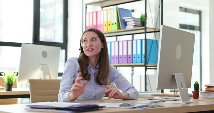 Female operator in headphones communicates with client