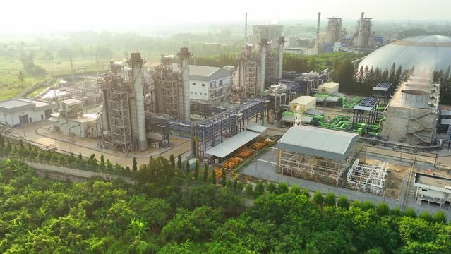 A Combined-Cycle Power Plant efficiently generates electricity by first burning natural gas to drive a gas turbine, then using the waste heat to produce steam and power a steam turbine. Aerial view.
