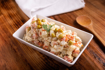 Russian Salad, also known as Olivier Salad. Very popular dish in several countries, the main ingredients are commonly potatoes, mayonnaise and vegetables such as peas, carrots, boiled eggs or chicken