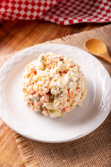 Russian Salad, also known as Olivier Salad. Very popular dish in several countries, the main ingredients are commonly potatoes, mayonnaise and vegetables such as peas, carrots, boiled eggs or chicken