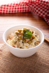 Russian Salad, also known as Olivier Salad. Very popular dish in several countries, the main ingredients are commonly potatoes, mayonnaise and vegetables such as peas, carrots, boiled eggs or chicken