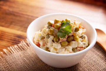 Russian Salad, also known as Olivier Salad. Very popular dish in several countries, the main ingredients are commonly potatoes, mayonnaise and vegetables such as peas, carrots, boiled eggs or chicken