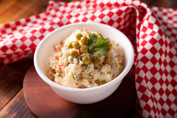 Russian Salad, also known as Olivier Salad. Very popular dish in several countries, the main ingredients are commonly potatoes, mayonnaise and vegetables such as peas, carrots, boiled eggs or chicken