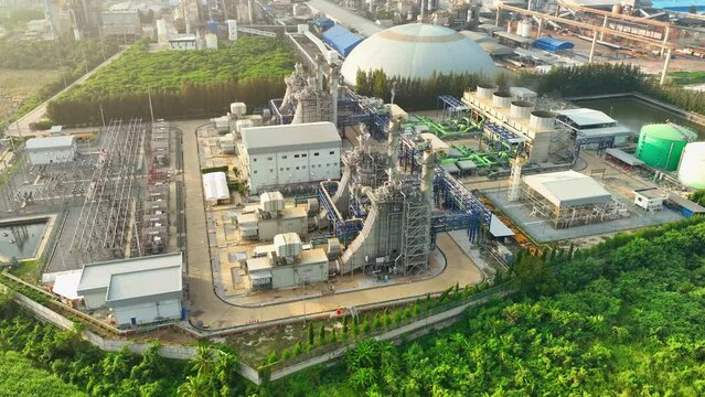 A Combined-Cycle Power Plant integrates gas and steam turbines to maximize energy extraction, achieving high thermal efficiency and reduced environmental impact. Aerial view drone. 4K.
