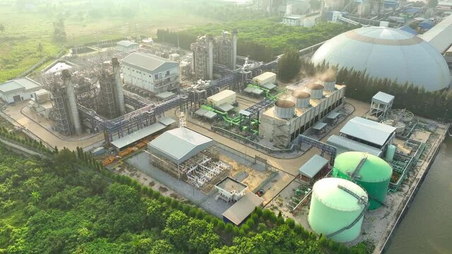 A Combined-Cycle Power Plant efficiently generates electricity by utilizing both gas and steam turbines, harnessing waste heat for enhanced energy production. Aerial view. 4K.
