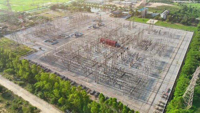 An electrical substation, captured from above by a drone, showcases a grid of transformers and power lines, vital for electricity distribution.
