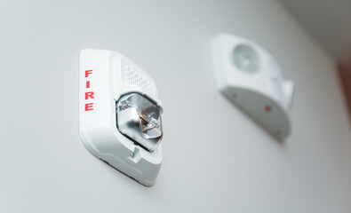 red fire alarm on a white wall, symbolizing safety and emergency preparedness
