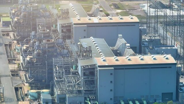 A strategic power facility is a linchpin in industrial strategy, ensuring uninterrupted power supply for manufacturing, ensuring a competitive edge. Aerial view drone.
