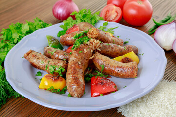 Grilled mumbar or sausage grill clodeup with onion, tomato and coriander served in dish isolated on...