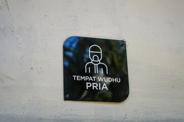 a sign for men's ablutions at a prayer room