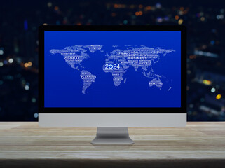 Start up business icon with words world map on computer screen on table over blur night light city tower, Happy new year 2024 global business start up online, Elements of this image furnished by NASA