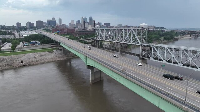 Kansas City on a cloudy day as seen from the Missouri River. Aerial rising shot of traffic on bridge and skyline.