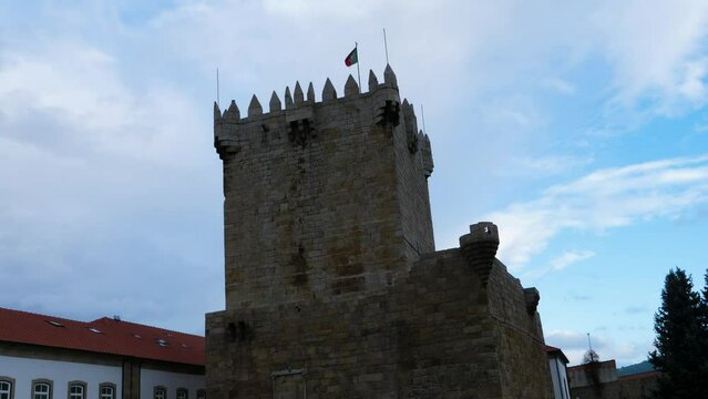 Static establishing view of castle tower and flag in Chaves Vila Real Portugal