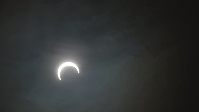 Moon Timelapse In The Sky With Clouds During Annular Solar Eclipse.
