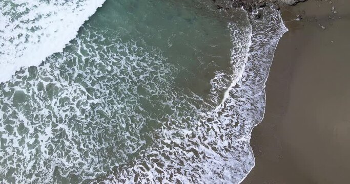 4K Drone Aerial View zooming out of beach waves and rock cliffs in brookings oregon northern california