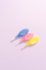 Template Colorful Dental Brushes Between Teeth Gum Braces on Pink Background, Interdental Brush Toothpick with Soft Bristles, Oral Tooth Cleaning Tool. Copy Space For Text, Vertical Plane