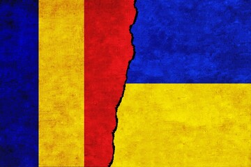 Ukraine and Romania painted flags on a wall with a crack. Ukraine and Romania relations. Romania and Ukraine flags together