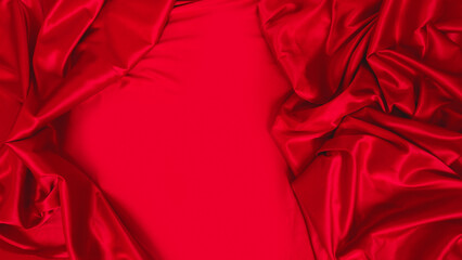 Red silk satin background. Soft folds on the smooth surface of the fabric. Luxury background with...