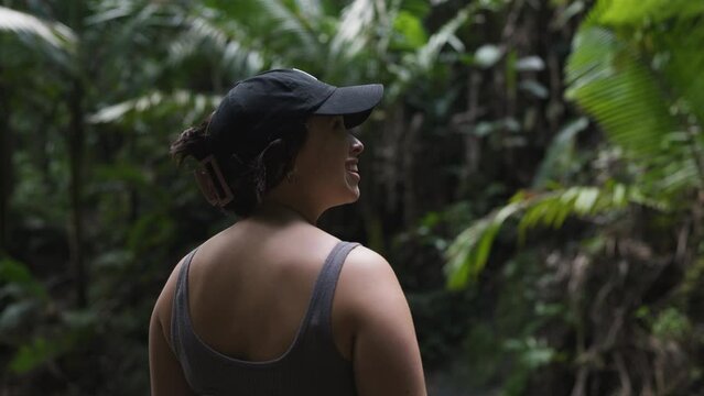 Slow motion shot of a woman admiring the view of a Puerto Rican Jungle