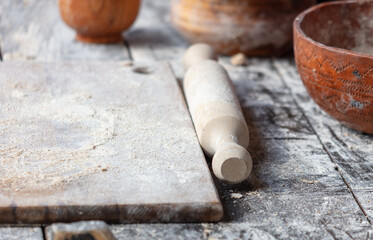 Rolling pin with flour on a wooden table
