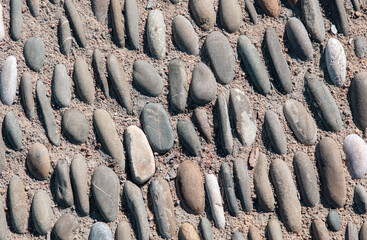 Pebble road as an abstract background. Texture