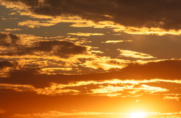 Golden sunset on the sky with clouds
