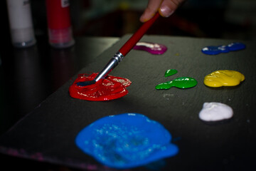 Young child painting with bold colors, kid's art creation, creative child