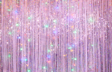 New Year party background of lilac tinsel and colored garland....