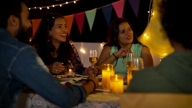 group of friends having fun during new year dining party - concept of birthday celebration, millennial lifestyles and weekend holidays