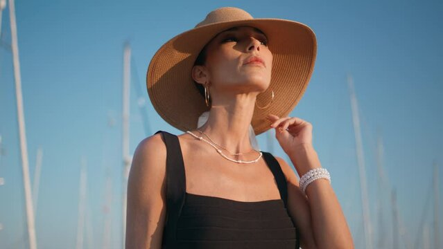 Straw hat girl relaxing on sunny nature close up. Portrait elegant woman posing