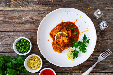 Roast chicken breast in bbq sauce on wooden table
