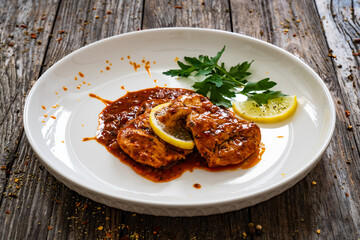 Roast chicken breast in bbq sauce on wooden table
