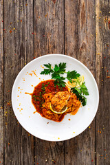 Roast chicken breast in bbq sauce on wooden table
