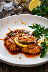 Roast chicken breast in bbq sauce on wooden table
