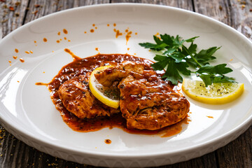 Roast chicken breast in bbq sauce on wooden table
