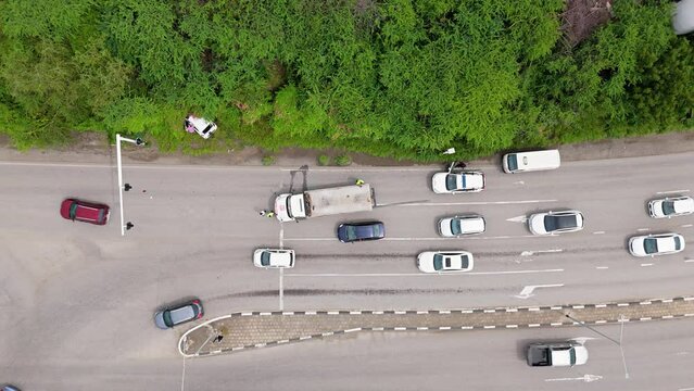 Cars swerve around crash accident site blocking traffic on tropical island