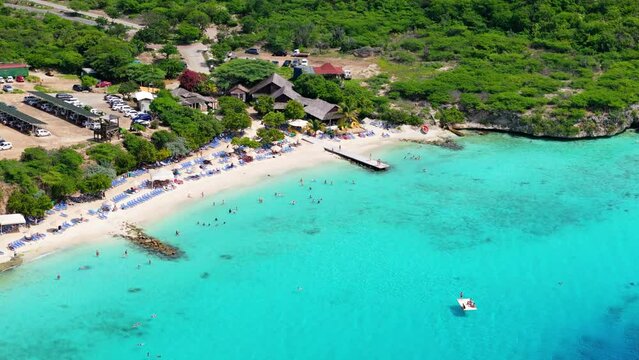 High angle drone view of Playa Porto Mari with swimmers and sunbathers
