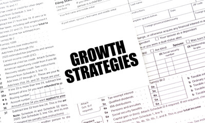 GROWTH STRATEGIES on white sticker with tax forms