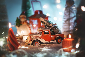 A Christmas display with a miniature car and a Christmas tree on the roof. A warm cinematic shoot...