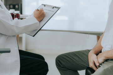 A doctor is counseling a young male patient about prostate cancer and venereal disease, including...