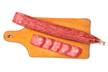 Smoked sausage on a cutting board. Sliced sausage on white background. Salami sausage on a wooden cutting board.