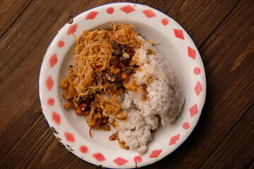 Nasi Campur, Nasi Rames. Rice with side dishes of fried vermicelli, stir-fried tempeh, anchovy sauce and fried peanuts. Indonesian food. Lemak rice.