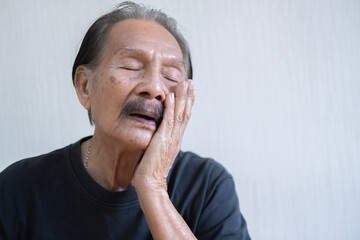 Asian unhappy elder man problems with gum pain studio shot isolated on beige background, Portrait...